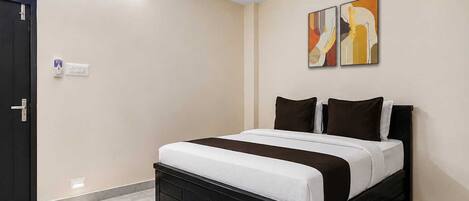 A bedroom with a bed, a ceiling fan, and a door.