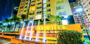 A multi-story building with a prominent sign reading 'SKY CENTER' and a water feature in front. - COSY HOMESTAY  (Thanh pho Chi Minh)