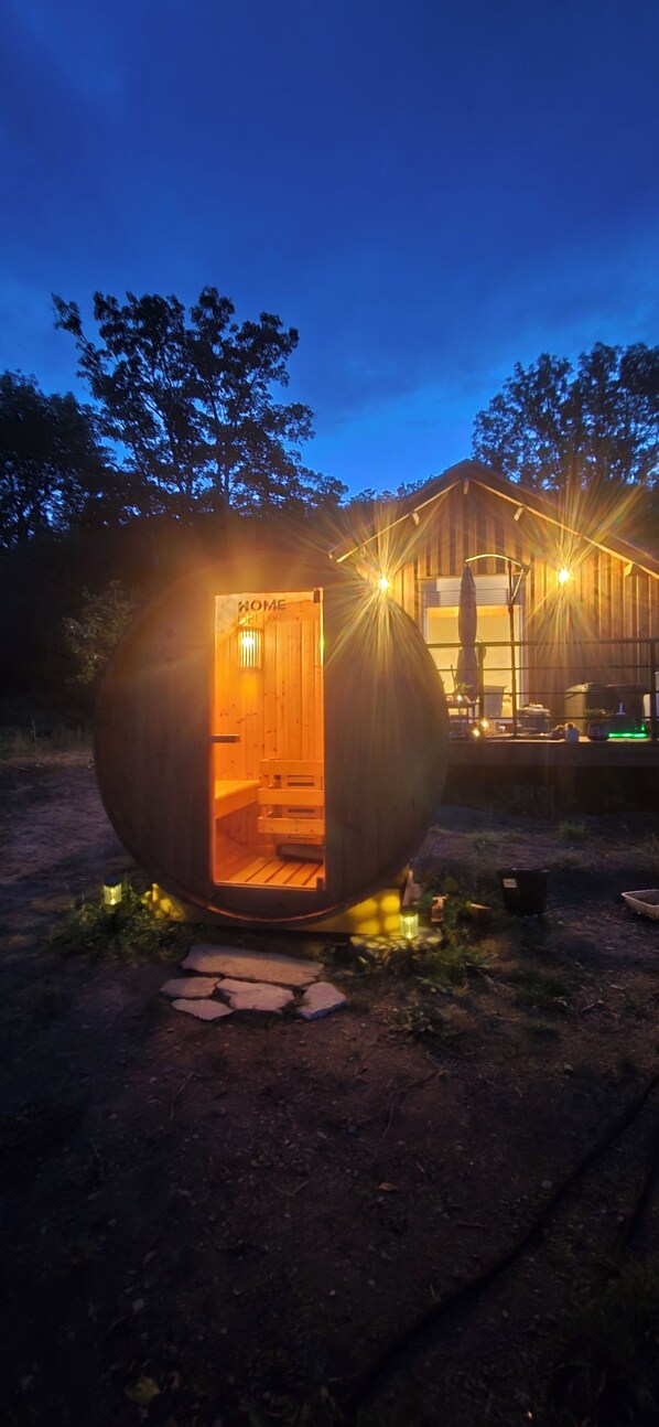 A spherical structure with an entrance labeled 'HOME' and a wooden building in the background.