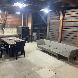 A rustic interior with a wooden table and chairs, a woven bench, and a tiled backsplash. - Villa La Pineta. Equipped with every comfort. Located in the marine protected area (Sicilia)