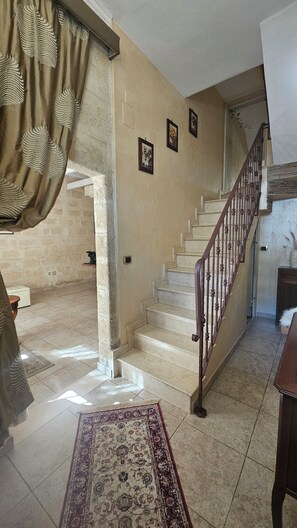 A staircase with a wooden handrail leading to an upper floor. - Just a few minutes from Bari—the perfect starting point for experiencing Puglia at its best (Capurso)