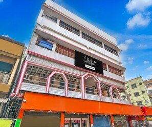 A multi-story building with a prominent sign on the second floor. - Classic Raj Guest House (Barakpur)