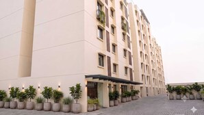 A multi-story hotel with a modern design, featuring a series of balconies and a covered entrance area. - Deluxe Hotel Urban Oasis (Pune)