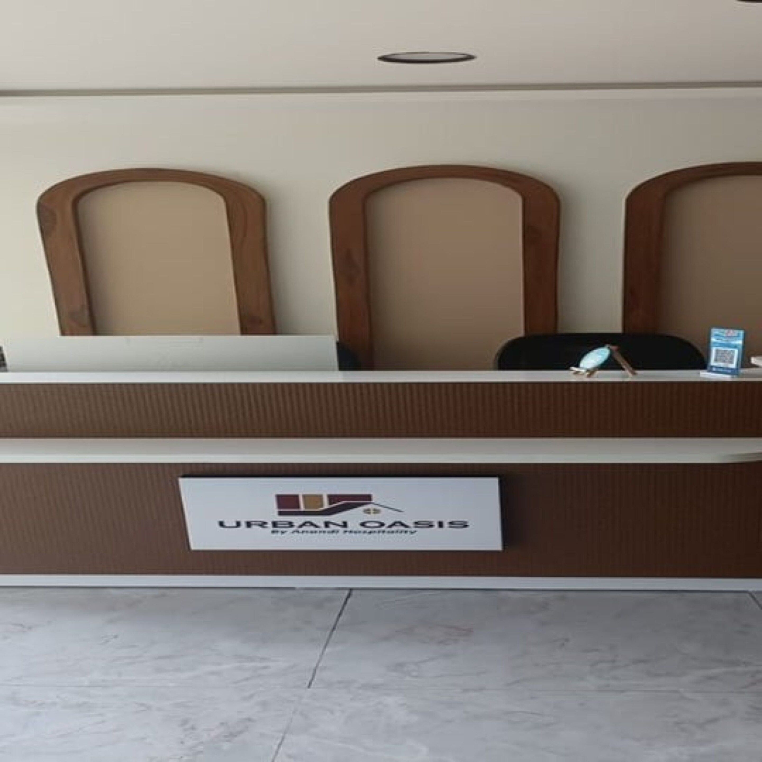 A reception desk with a sign reading 'URBAN OASIS by Anshul Design.'