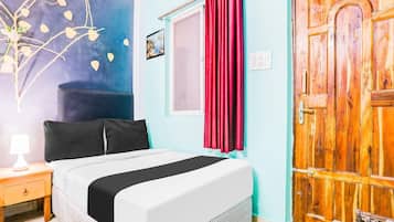 A room with a bed, a nightstand, a wall with a painting, a window with curtains, and a wooden door.