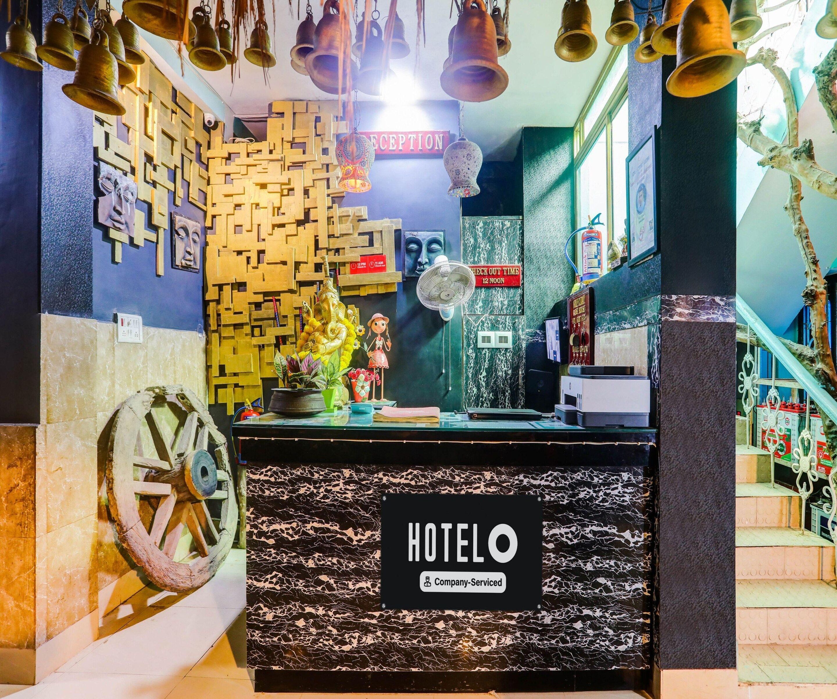 A hotel reception desk with a sign reading 'HOTELO Company-Serviced.'