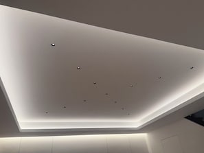 A ceiling with recessed lighting and a sloped design. - Designer River District Townhouse (Fort Myers)