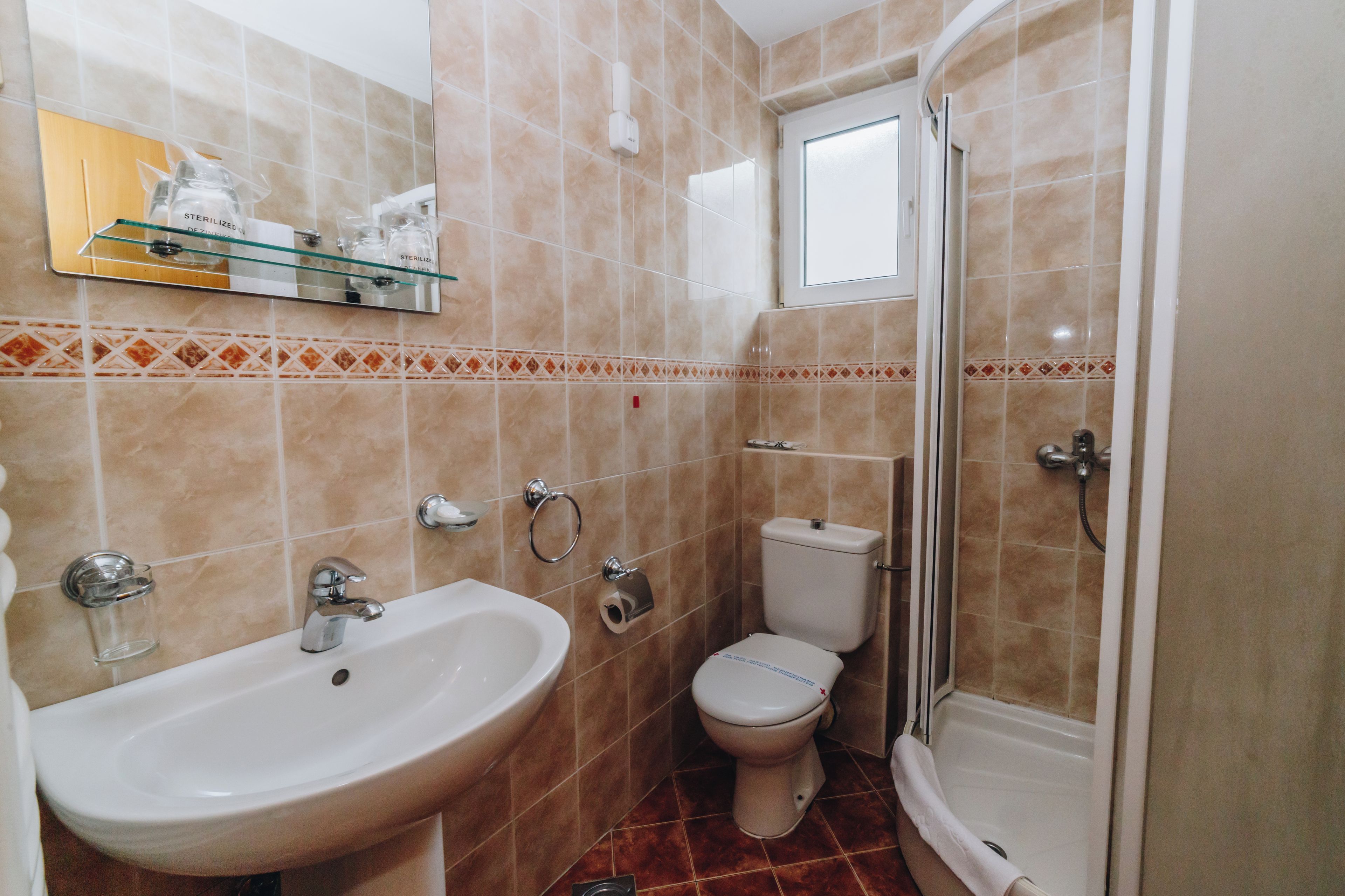 A bathroom with a sink, toilet, and shower.