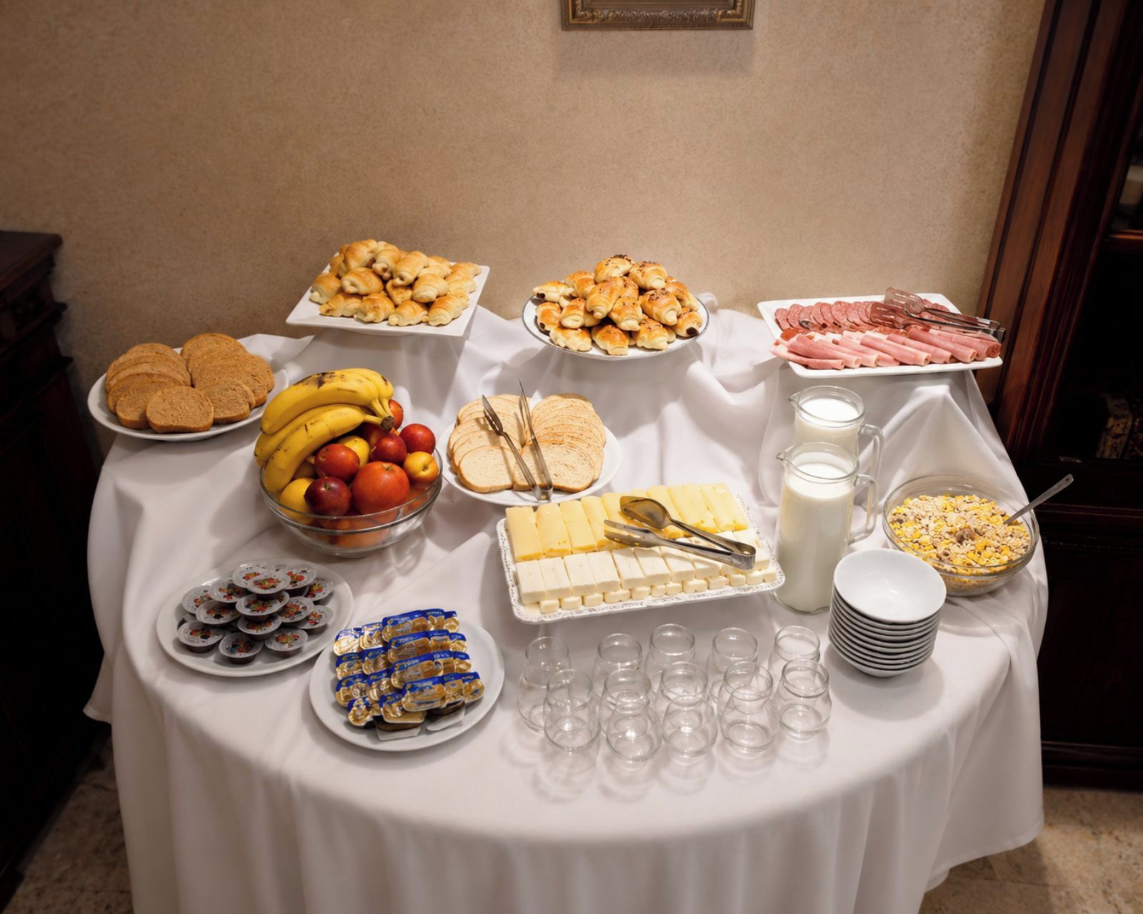A buffet table with various food items and beverages.