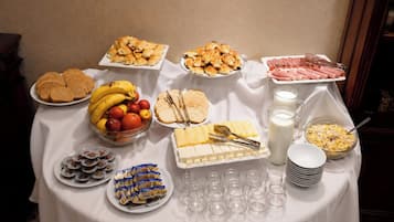 A buffet table with various food items and beverages.