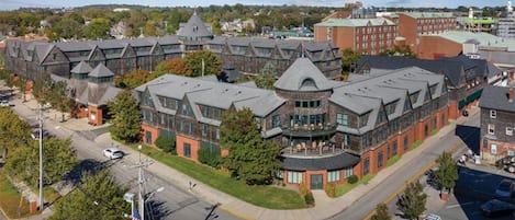A multi-story building with a central courtyard, surrounded by parking and roads.