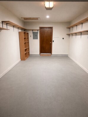 A room with a wooden door, built-in shelving, and a carpeted floor. - 2-bedroom condo in quiet, charming Delta, CO (Delta)