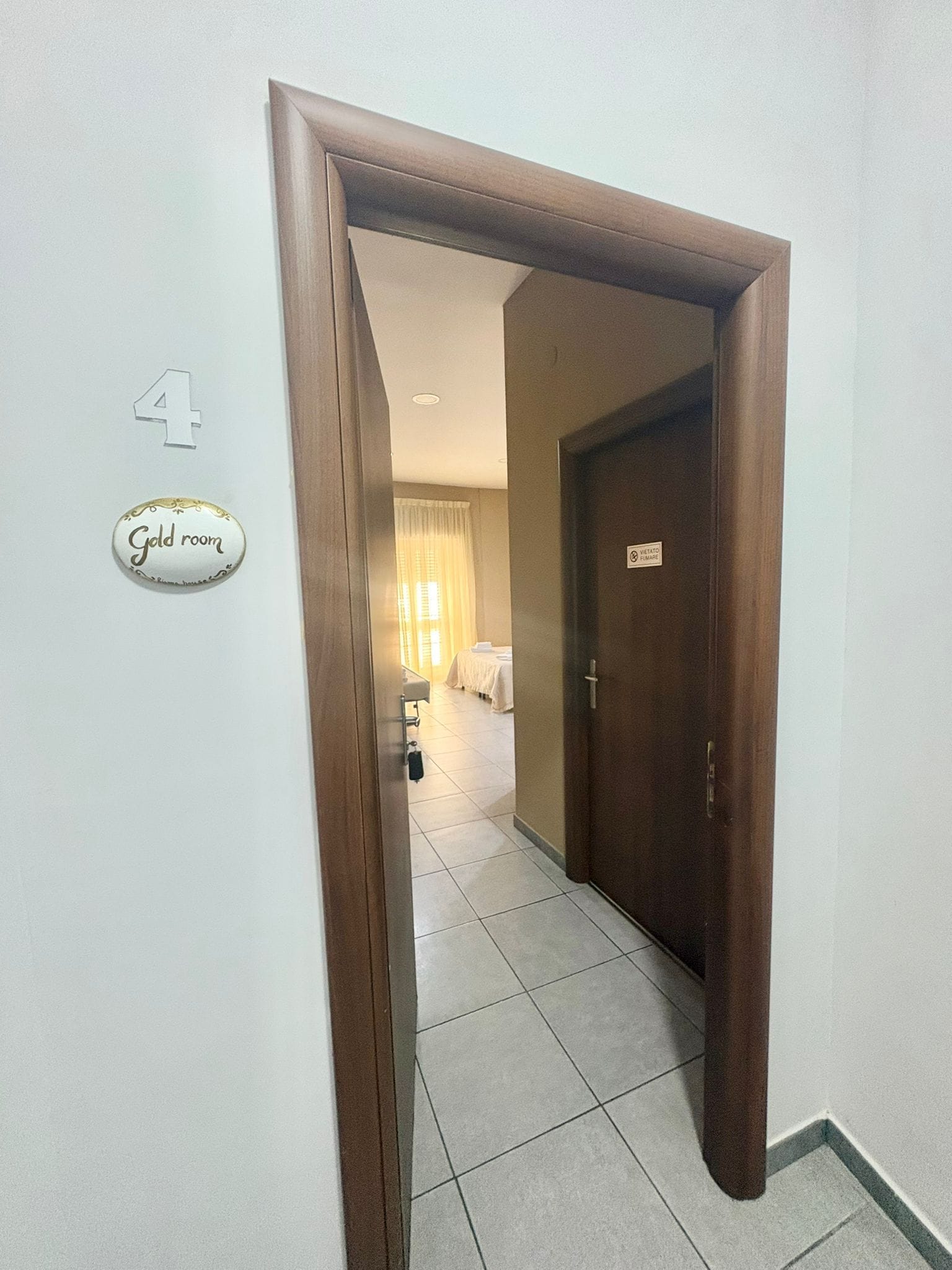A hotel room entrance with a door marked '4' and a sign indicating 'Gold room.'