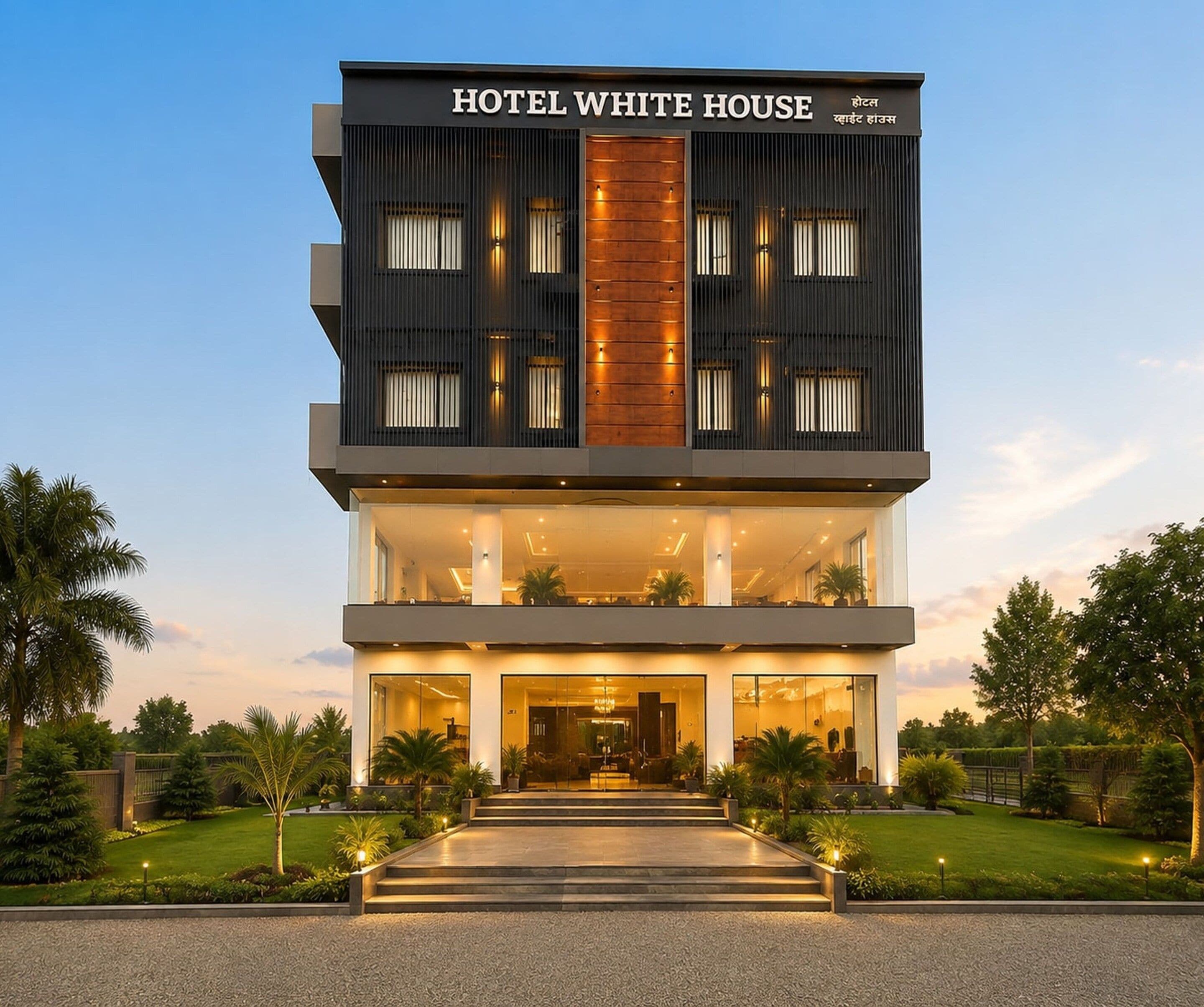 A multi-story hotel with a prominent entrance, large windows, and a well-lit facade.