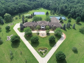 A large estate with a central building, surrounded by manicured lawns and trees. - Private 35-Acre Resort Near Wisconsin Dells - Indoor Pool, Golf Sim, Sleeps 30+ (Camp Douglas)