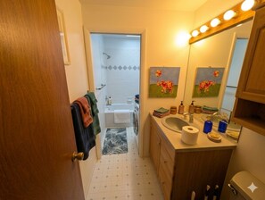 A bathroom with a sink, mirror, and towel rack. - Spacious 4 bedrooms 2 bath rental near bus line Sundance Film Festival 2027 (Boulder)