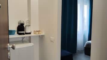 Ein Hotelzimmer mit Küchenzeile, einem Bett und Blick nach draußen.