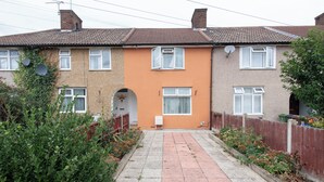 A residential building with a central entrance, a small porch, and a pathway leading to the entrance. - Blue Becontree in Goresbrook Village, London (Dagenham)