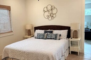 A neatly arranged bedroom with a bed, two bedside tables, and a wall decoration. - Close to Beaches ~ Downtown Venice ~ Bike Trail ~ Park (Nokomis)