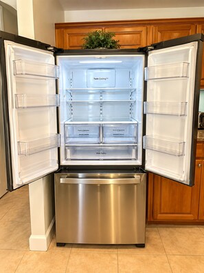 A stainless steel refrigerator with multiple compartments, including a 'Twin Cooling' section and a 'Wide Pantry'. - Brilliant 1-bedroom apartment with AC in vibrant Orlando (Orlando)