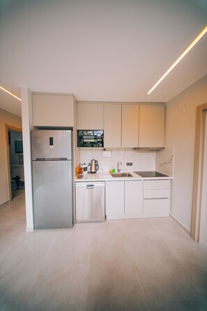 A modern kitchen with a built-in refrigerator, microwave, and stove.