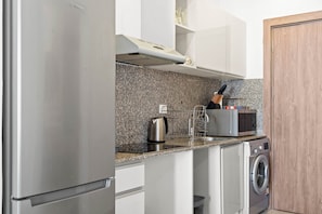 A modern kitchen with stainless steel appliances, granite countertops, and a built-in oven. - Maraya Hideaway Private Jacuzzi| Nesty Hospitality (Second Hurghada)