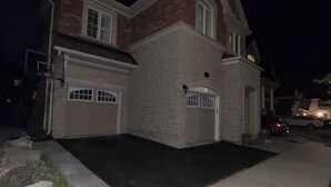 A two-story house with a garage and a driveway. - Perfect basement apartment in Milton (Milton)