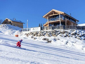 A ski resort with a wooden lodge and a sign for ALPS RESORTS. - Cabin in Pichl Near Schladming With Sauna (Schladming)