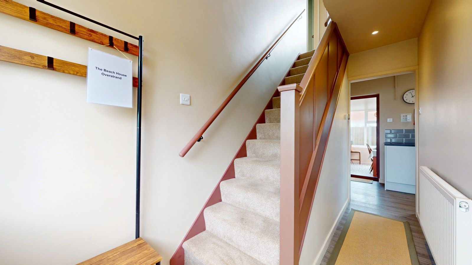 A staircase with carpeted steps leading to an upper floor.