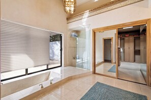 A bathroom with a bathtub, a shower, and a vanity with a sink. - 4-bedroom estate with 25 foot ceilings, formal salon and resort-style pool (Paradise Valley)