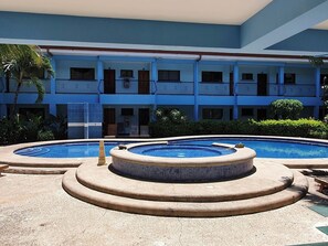 A hotel with a swimming pool area, including a hot tub and a standard pool. - Marina Loft Condo #212 (Sardinal)