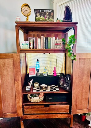 A wooden bookshelf with books, a lava lamp, and a small plant. - Serene 2-bedroom apartment with concierge in vibrant St. Louis (St. Louis)