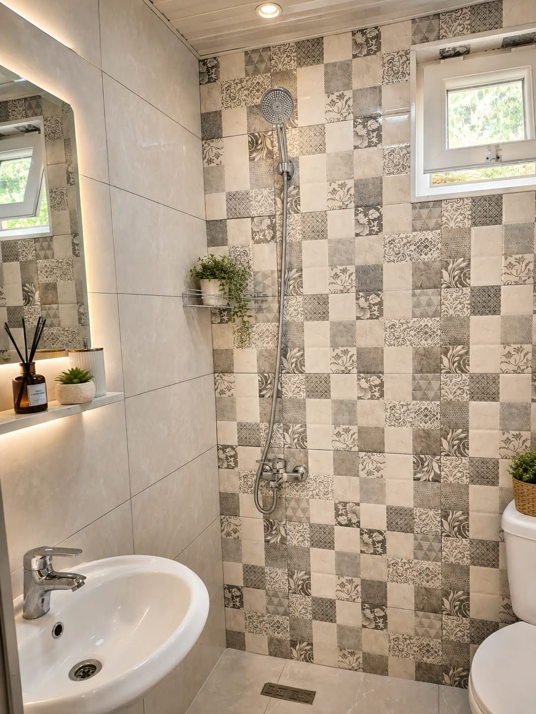 A bathroom with a checkered tile wall, a shower, a sink, and a toilet.