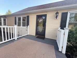A house with a front porch, a door, and a small deck area. - NEW LISTING! Escape to the Cape Beach Retreat (Cape May)