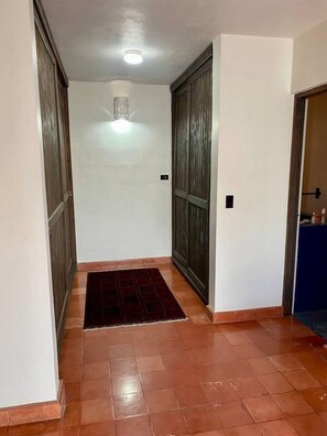 A hallway with a tiled floor, a dark mat, and a door on the right. - 4 Bedroom home-amazing location in downtown Cabo San Lucas (Cabo San Lucas)
