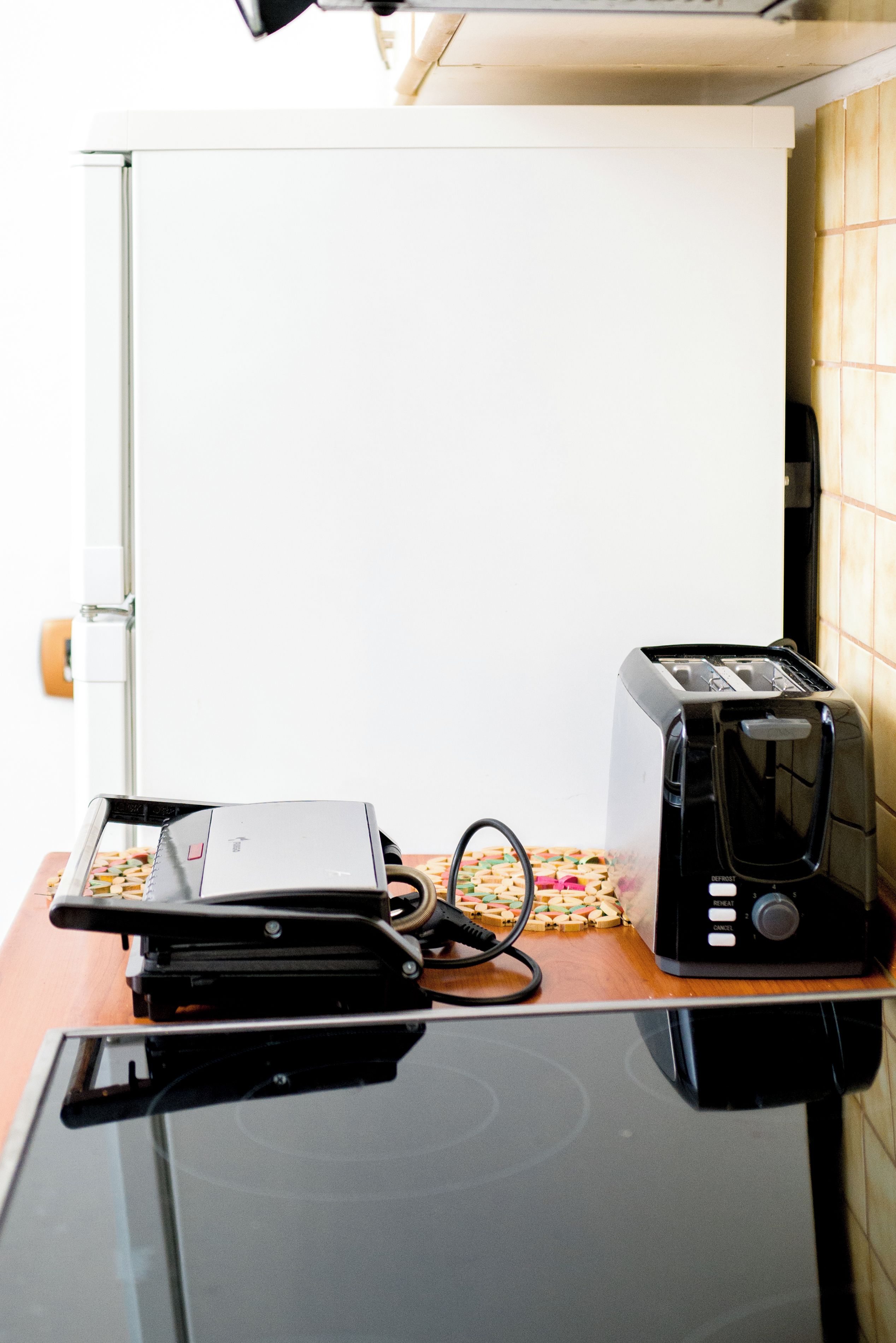 A kitchen with a toaster and a coffee maker on a countertop.