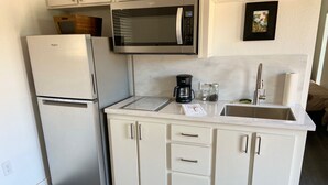 A compact kitchen with a refrigerator, microwave, coffee maker, and a sink. - "The Office" - located the beautiful wine & horse country of Santa Barbara (Santa Ynez)