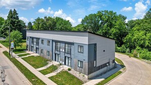 A modern two-story building with a flat roof, large windows, and a visible address number. - Gray's Lake - 2BR 1BA, Washer, Parking - Near CBD Downtown (Des Moines)