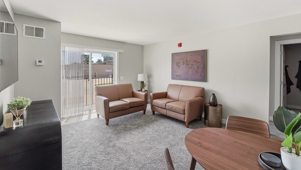 A modern living room with two sofas, a coffee table, and a dining table. - Gray's Lake - 2BR 1BA, Washer, Parking - Near CBD Downtown (Des Moines)