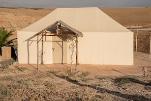 A single-story building with a simple gabled roof and a single door.