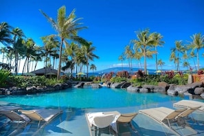 A clear blue pool surrounded by palm trees and lounge chairs. - Oceanfront -Hyatt Vacation Club - 2BR Upper Floor - Ka'anapali Beach - Sleeps 7 (Lahaina)