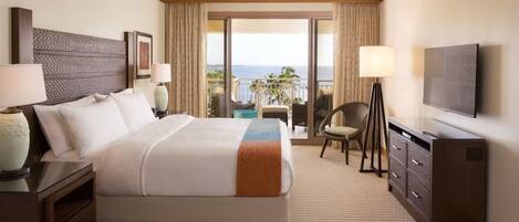 A hotel room with a bed, a television, a desk, a chair, a balcony with a view, and a ceiling fan.