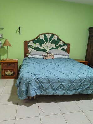 A bedroom with a bed, a nightstand, a lamp, and a wardrobe. - Spacious 2-Bedroom Ground-Floor Home in Downtown Loreto (Loreto)