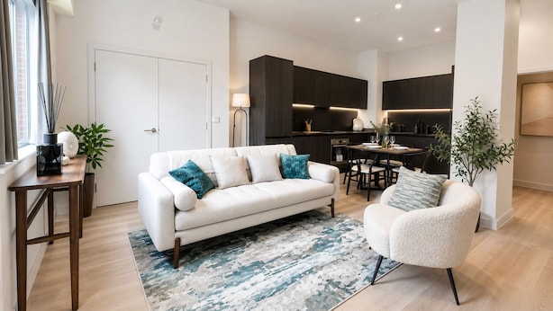 A modern living room with a white sofa, a matching armchair, and a dining area with a table and chairs. - Downtown Manchester Townhouse w/ Garden & Modern (Greater Manchester)