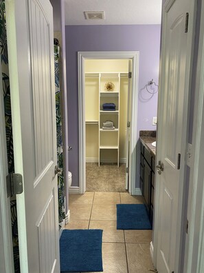 A hallway with a closet, a blue mat, and a tiled floor. - Convenient and private studio with relaxing deck (Holladay)