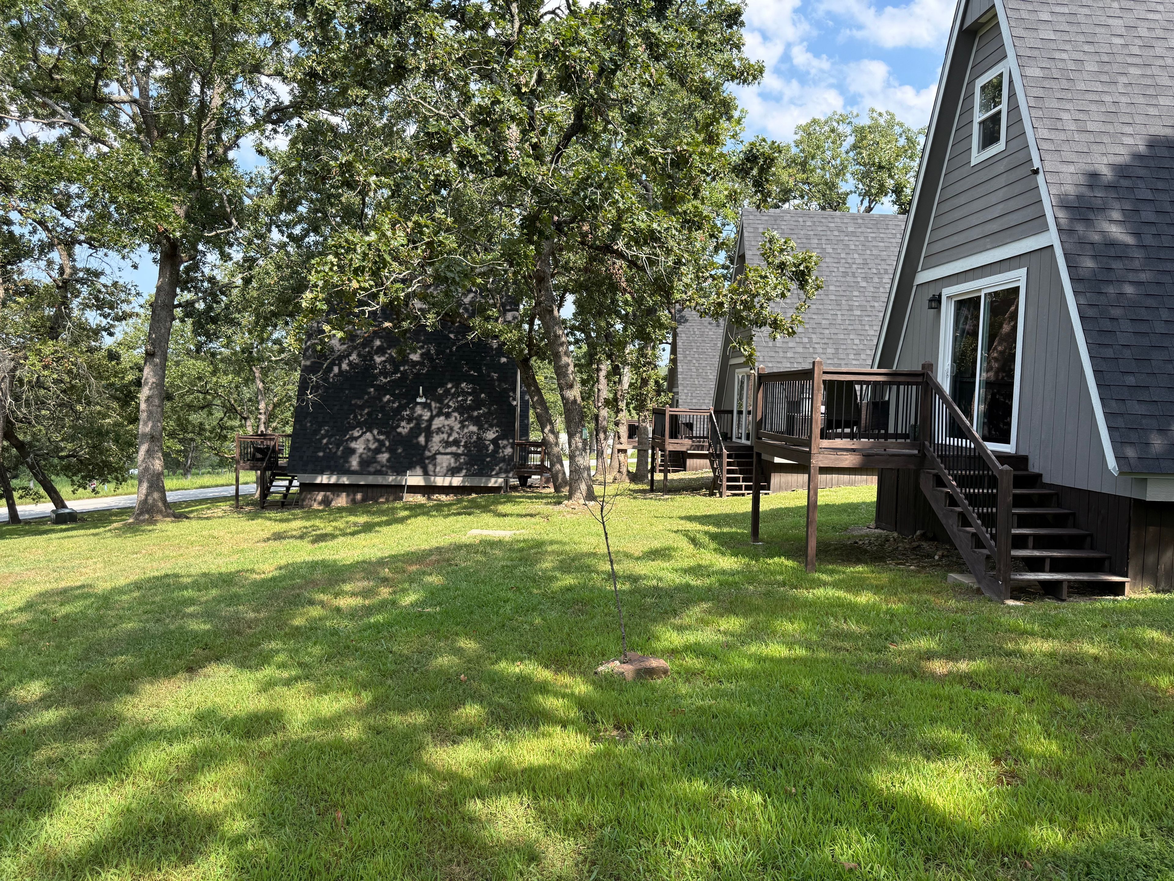 A house with a deck and stairs leading to a porch.