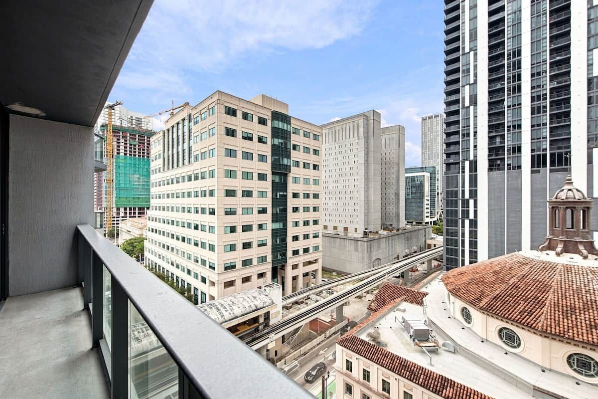 A high-rise building with multiple floors, a clear sky, and a mix of modern and traditional architecture.