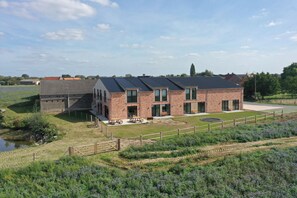 A modern two-story building with a brick facade, large windows, and a flat roof. - Den Kerselaer Group Holiday Home - Langemark       -   1st- FLOOR (Langemark-Poelkapelle)