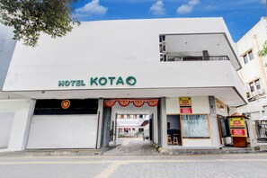A hotel named 'HOTEL KOTAO' with a visible entrance and a closed garage door. - Hotel Grand Kota (Yogyakarta)