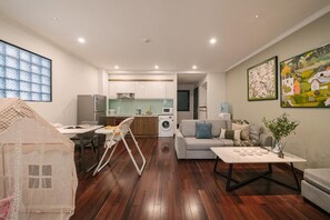 A modern apartment with a dining area, kitchen, living room, and a playhouse. - Hanoi Lux Lakeside Hotel and Apartment (Giang Vo)